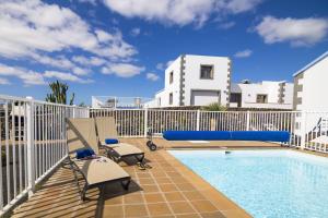 balkon z basenem i białym płotem w obiekcie Villas & Apartamentos Tao Mazo w mieście Lajares
