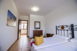 Łóżko lub łóżka w pokoju w obiekcie Villas & Apartamentos Tao Mazo