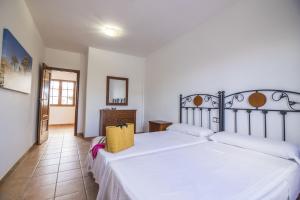 Łóżko lub łóżka w pokoju w obiekcie Villas & Apartamentos Tao Mazo