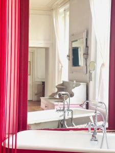 a bathroom with two sinks and a large mirror at Le château de Bertreville Saint Ouen entre mer et campagne in Bertreville-Saint-Ouen