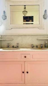 a pink bathroom with a mirror and a sink at Le château de Bertreville Saint Ouen entre mer et campagne in Bertreville-Saint-Ouen +23 photos