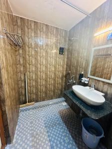 a bathroom with a sink and a shower at Neon Nirvana Deluxe Apartments in North Goa Near Calangute Candolim Anjuna in Nagoa-Bardez