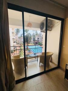 a room with a view of a balcony with a tub at Neon Nirvana Deluxe Apartments in North Goa Near Calangute Candolim Anjuna in Nagoa-Bardez