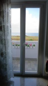 a sliding glass door with a view of a balcony at Alby suite in Termoli
