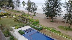 an aerial view of a resort with a pool and a beach at Ang Roxy Apartment B in Sematan