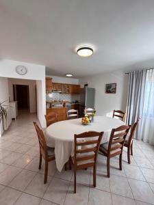 a kitchen and dining room with a table and chairs at Apartments Marina in Sveti Filip i Jakov