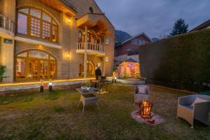 a house with a yard with a table and chairs at SaffronStays King Mahal in Srinagar