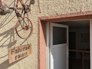 a bike hanging on the side of a building with a door at Hotel & Restaurant Brühler Hof in Wintrich