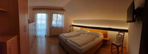 Postel nebo postele na pokoji v ubytování Privatzimmer am Weinbrunnen