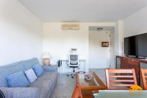 a living room with a couch and a table at Retama Golf by Cadiz Time in Novo Sancti Petri