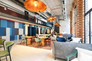 a restaurant with tables and chairs in a building at Coliving for Master, Postgrads and Language Learners in Barcelona