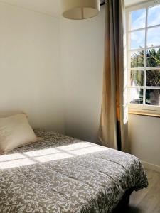 Ένα ή περισσότερα κρεβάτια σε δωμάτιο στο Appartement familial lumineux à 100m de la plage