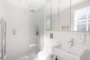 a white bathroom with a toilet and a sink at HAFH in Farringdon- Stylish 1Bedroom Apartments in London +33 photos