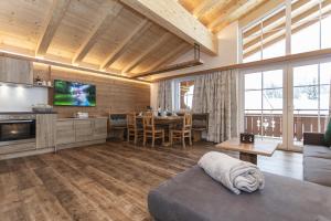 a living room with a couch and a table at Ferienwohnungen Recherhof in Hochfilzen