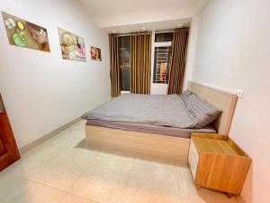 a small bedroom with a bed and a window at Home 33 in Sapa