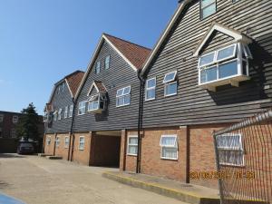 a large house with a black roof at Oyster Fleet Hotel in Canvey Island