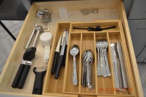 a wooden tray with utensils in a drawer at Dimond Abode Vacation Home #2 Oakland Dimond District in Oakland
