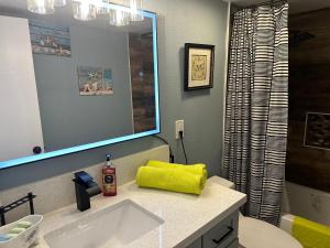 a bathroom with a yellow towel on a sink at Casada in Las Vegas +21 photos