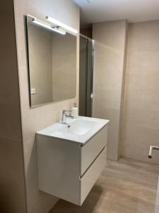 a bathroom with a white sink and a mirror at Pelayo Living in Castellón de la Plana +28 photos