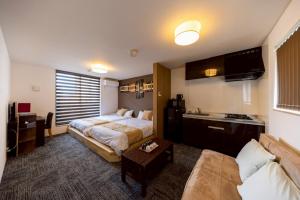 Ένα ή περισσότερα κρεβάτια σε δωμάτιο στο Apartment Hotel STAY THE OSAKA