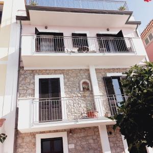 a building with balconies on the side of it at Casa vacanze e B&B Oltremare in Marina di Camerota