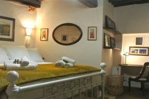 a bedroom with a bed with a mirror on the wall at Casa Alberi in Volterra
