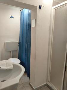 a bathroom with a toilet and a sink and a shower at Il Ginepro in Alghero +8 photos