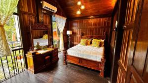 a bedroom with a bed and a large mirror at Charming Nature Kampung Home for Family Getaways in Benta +19 photos