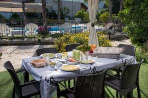 a table with a blue table cloth and food on it at Song of Galilee in Elifelet