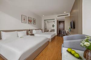 Postel nebo postele na pokoji v ubytování ELC Da Nang Hotel