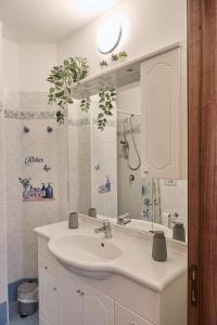 a bathroom with a sink and a mirror at La Casa di Caterina in Peschici +19 photos