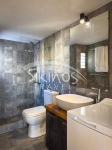 a bathroom with a toilet and a sink at Beachfront Cycladic House in Chora Folegandros
