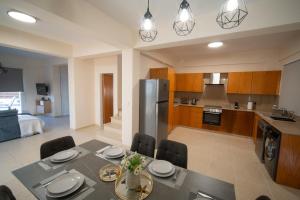 a kitchen and dining room with a table and chairs at Coastal Retreat Protaras in Protaras