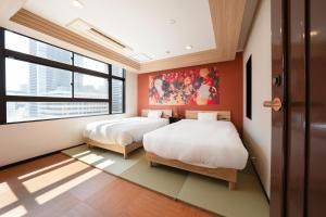 Postel nebo postele na pokoji v ubytování Zen House Umeda