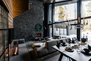a living room with a couch and a table at Villa Laponia - Borealis in Äkäslompolo