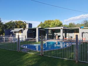 a fence around a swimming pool in front of a house at Zonneblom Guest House in Middelburg