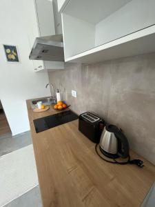 a kitchen with a sink and a toaster on a counter at Apartments Fishers in Vodice