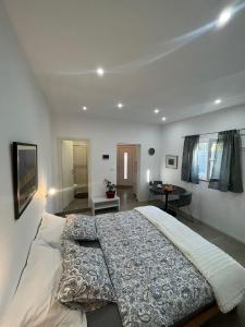 a bedroom with a large bed and a bathroom at Apartments Fishers in Vodice