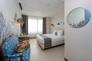 Postel nebo postele na pokoji v ubytování Hôtel Le Grand Barnum