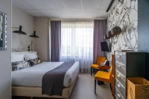 Postel nebo postele na pokoji v ubytování Hôtel Le Grand Barnum