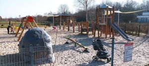 a playground with a slide and a swing set at Studio Sopot Twins in Sopot
