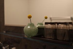 a green vase with a flower in it on a shelf at Excellent Hotel - Vacation STAY 50210v in Kyoto