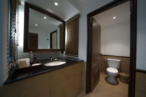 a bathroom with a sink and a toilet and a mirror at Ao Prao Resort in Ko Samed
