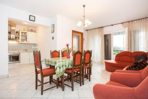a kitchen and dining room with a table and chairs at Two Bedroom Apartment Sonja with Seaview in Punat +14 photos