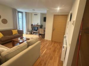 a living room with a couch and a table at Winahost Apartamento Temporal Esterri d'Àneu in Esterri d'Àneu