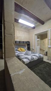 a bedroom with a large bed in a building at Valletta Authentic Apartment in Valletta