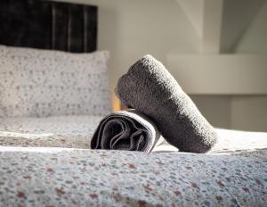 a pair of socks sitting on a bed at Dwell Living North Bridge Apartments in Sunderland +102 photos
