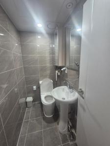 a bathroom with a toilet and a sink at All Stay Hostel in Seoul +54 photos