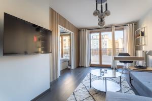 a living room with a couch and a table at Charmant appartement proche de Paris in Vincennes