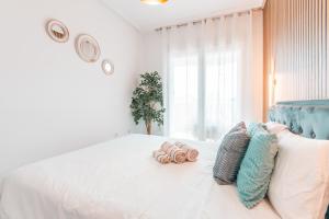 a bedroom with a bed with two pillows on it at Design Seascape apartment in Orihuela Costa